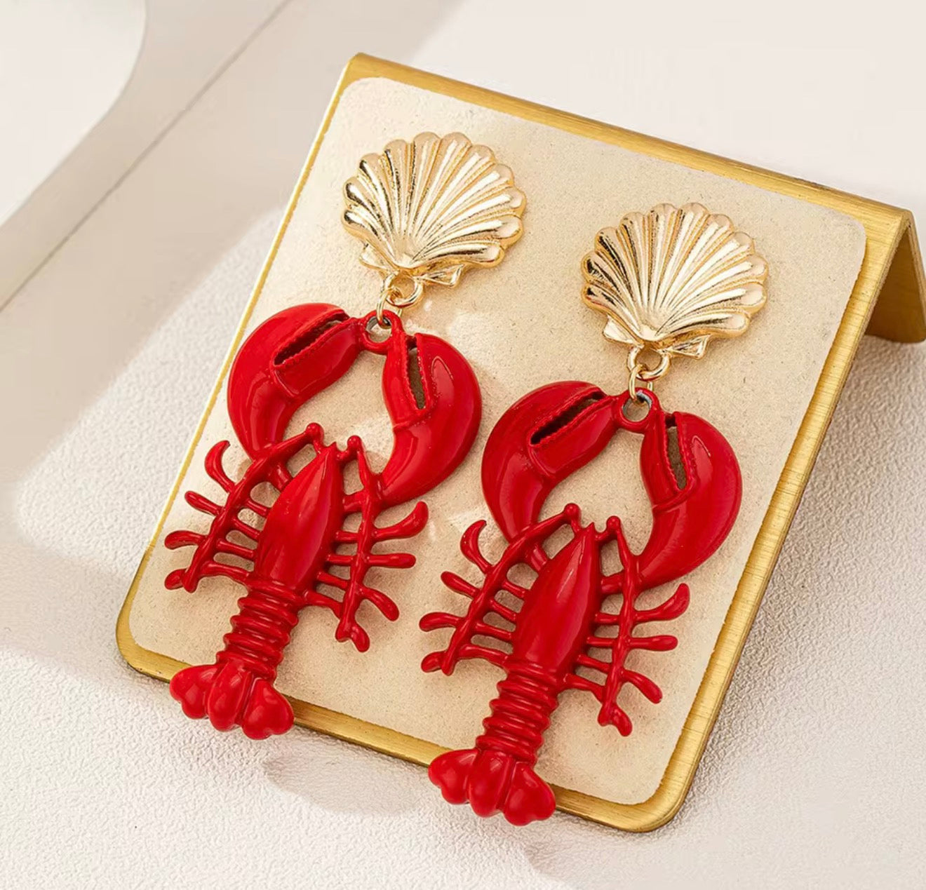 Red enamel lobster drop earrings with a gold-tone scallop seashell stud